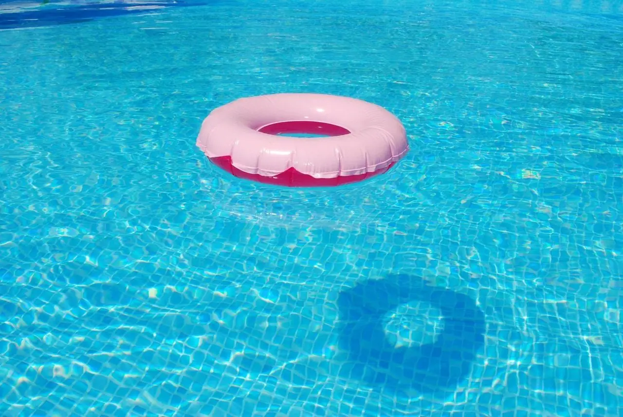Pink pool float on clear turquoise pool water